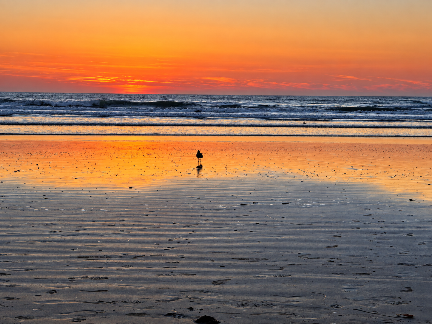 Orange sunset reflected across Pismo Beach